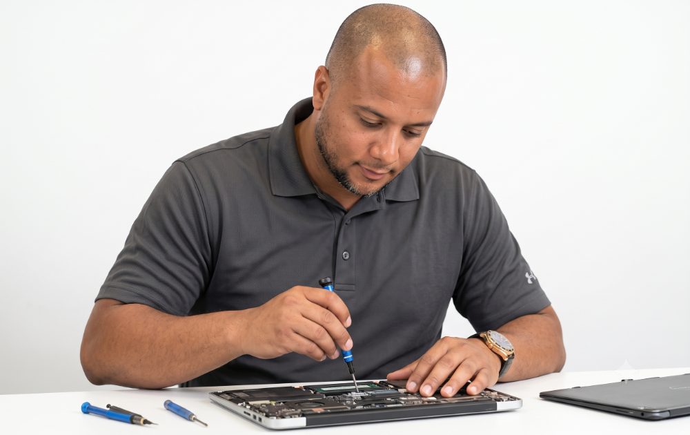 Technician repairing a laptop mainboard
